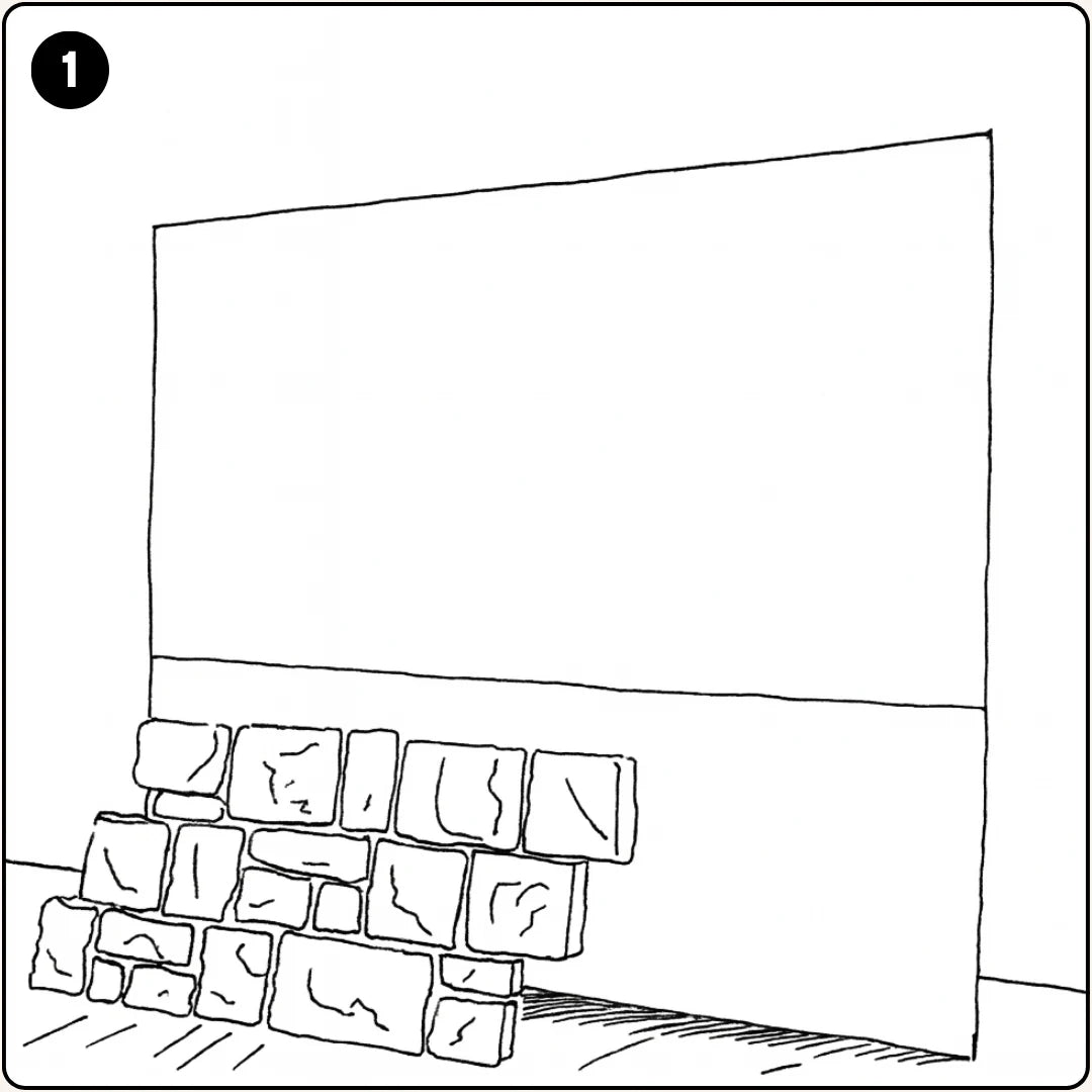 Pared limpia con la línea base marcada y varios paneles efecto piedra apoyados en el suelo listos para instalar.